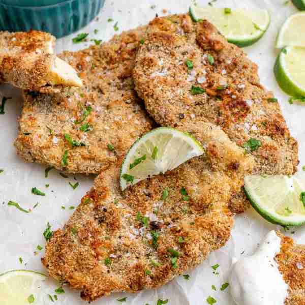 This Baked Crispy Coconut Chicken + Creamy Coconut-Lime Dip will make the entire family satisfied!...
