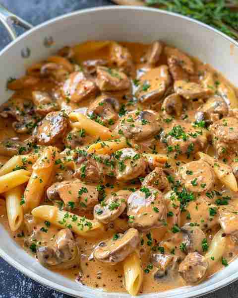 Classic Beef Stroganoff 🍖🍝 Ingredients: 1 lb beef (sirloin or tenderloin), thinly sliced 1 tablesp...