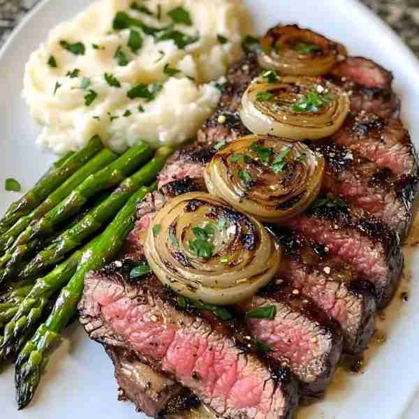 Grilled Steak with French Onions, Mashed Potatoes, and Asparagus Ingredients: - 2 ribeye steaks - Sa...
