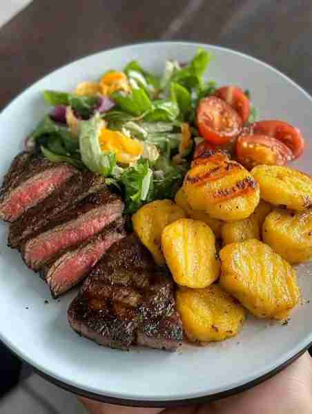 Savor the Flavor: Grilled Steak with Tostones & Fresh Salad Ingredients: 2 beef steaks, 1 tbsp oli...