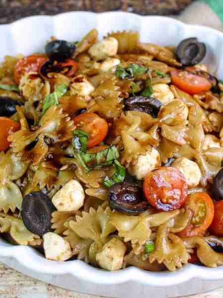 Every bite is full of fresh tomatoes, basil, mozzarella and black olives, all tossed with balsamic v...