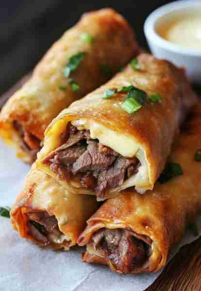 Philly Cheesesteak Egg Rolls🥩🧀 Ingredients: 1/2 lb thinly sliced steak (like ribeye) 1/2 onion, fi...