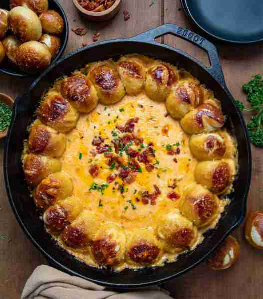 The dip that steals the show! 🥨🧀🍺 Warm, melty beer cheese loaded with sharp cheddar, bacon, and c...