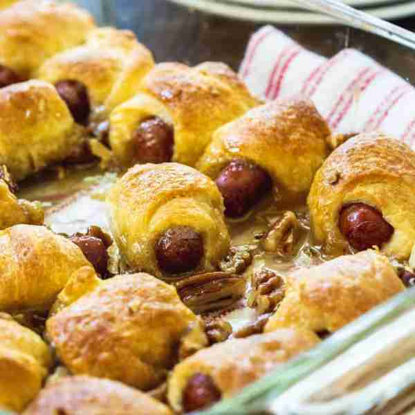 Sweet Little Smokies Rolls- cocktail wieners are wrapped in crescent roll dough and baked in a brown...