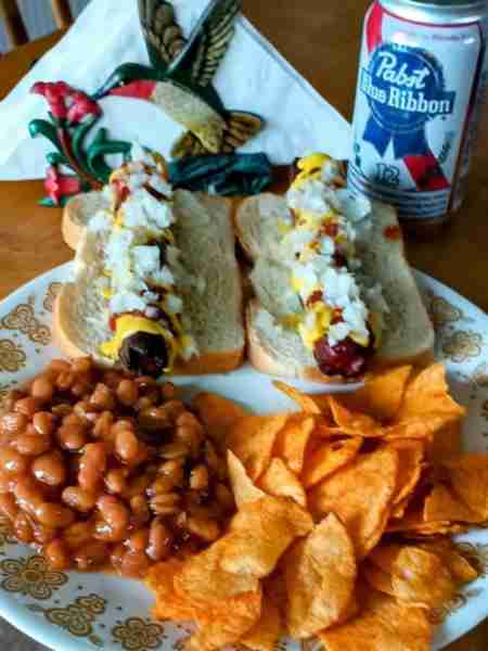 Hotdogs mustard, onions and ketchup bb chips, pork beans with a PBR