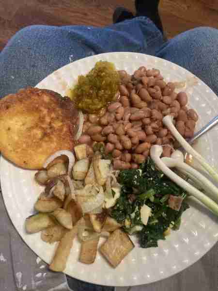 Pinto beans , hot water corn bread, fried potatoes, spinach with wild onion, bacon, chopped boiled e...