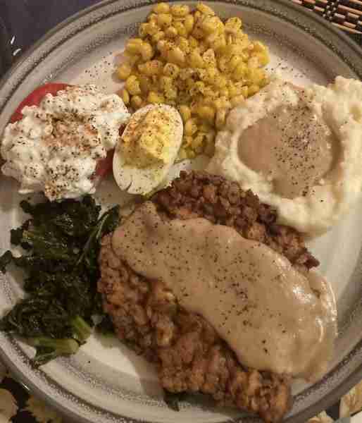 Son’s birthday supper…chicken-fried steak, kale, tom & cottage cheese, corn, mashed pot & gravy, dev...