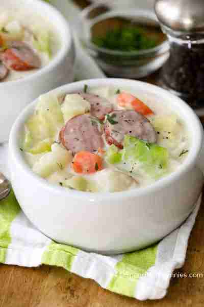 https://www.spendwithpennies.com/cabbage-soup-recipe-with-sausage/ Cabbage soup with slices of smoke...