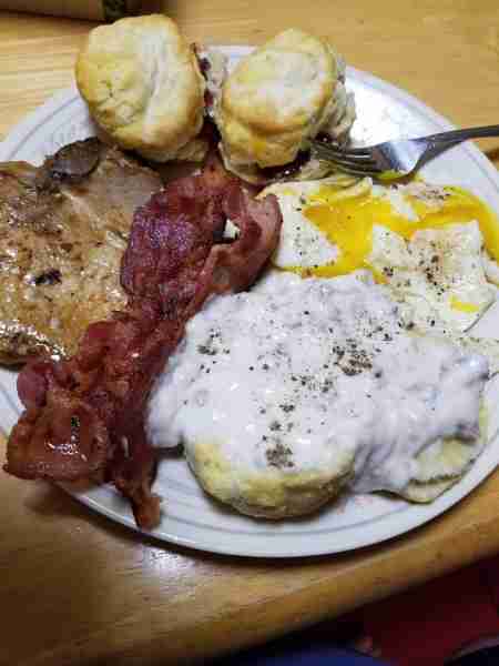 Supper tonight was a three meat breakfast. Sausage gravy, pork chop and bacon with over easy eggs an...