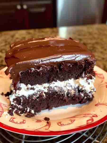 Ding Dong Cake 1 box of Chocolate cake mix, bake as directed when cake is done let sit 10 min , then...