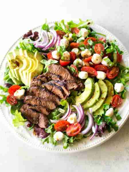 This Caprese Steak Salad combines tender, juicy steak with fresh tomatoes, mozzarella, and basil for...