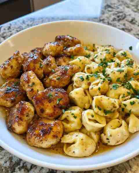Garlic Butter Chicken Bites & Creamy Alfredo Tortellini Ingredients: For the Chicken Bites: 1 lb bon...