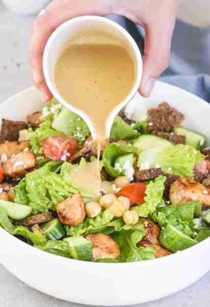 Our Greek Inspired Chicken Salad with Tahini Vinaigrette and Homemade Croutons may seem like a regul...