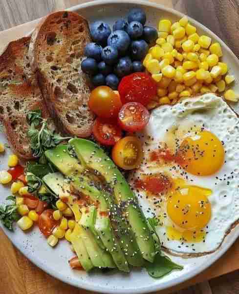 Healthy Breakfast Plate 🍞🥑🍳🌽🫐🍅🌿 Ingredients: 2 slices toasted bread 🍞 2 eggs sunny-side up...
