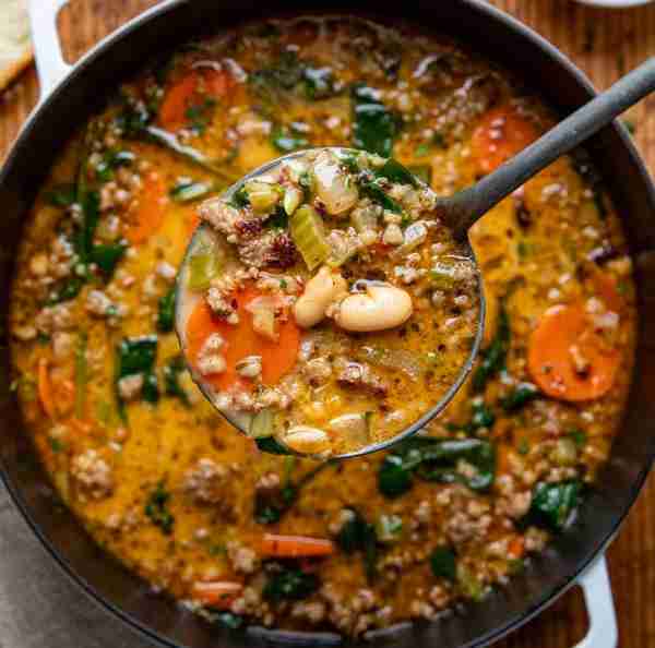 WOW is this one good!! Tuscan White Bean Soup Ingredients ▢1 pound mild Italian sausage ▢1 large yel...