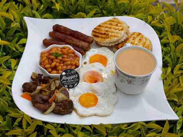 "Start your day the Maggie’s way! This hearty breakfast plate comes with perfectly fried eggs, juicy...