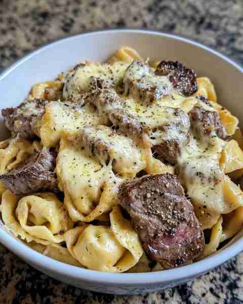 Philly Cheesesteak Tortellini Bake with Provolone Drizzle Ingredients: 1.5 pounds ribeye steak, thi...