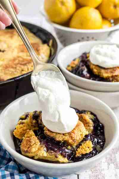 Lemon Blueberry Dump Cake with Almond Whipped Cream is an easy, no mess recipe made with pantry ingr...