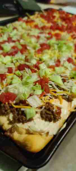 crescent roll taco pizza spread 2 cans of rolls out onto a baking pan. poke a few holes with a fork....