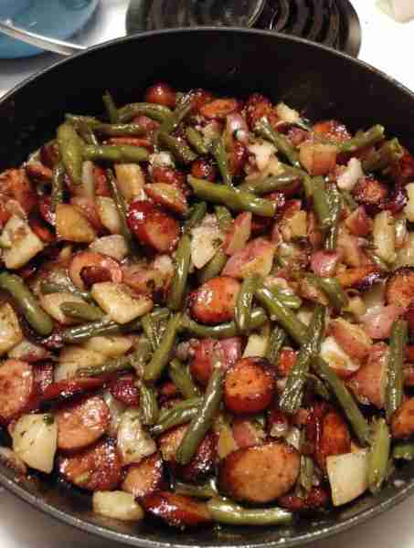 Sautéed potatoes and fresh green beans with smoked sausage. I used the purple potatoes for this, but...