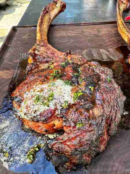 Grilled tomahawk steak topped with butter
