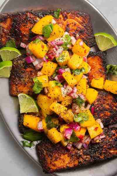 Seared salmon topped with a refreshing mango salsa, creating a delicious balance of savory and sweet...