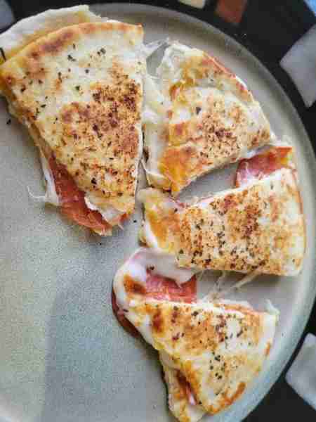 Easy and cheap pizza quesadilla. Cook just like you would a normal quesadilla but stuff with pizza t...