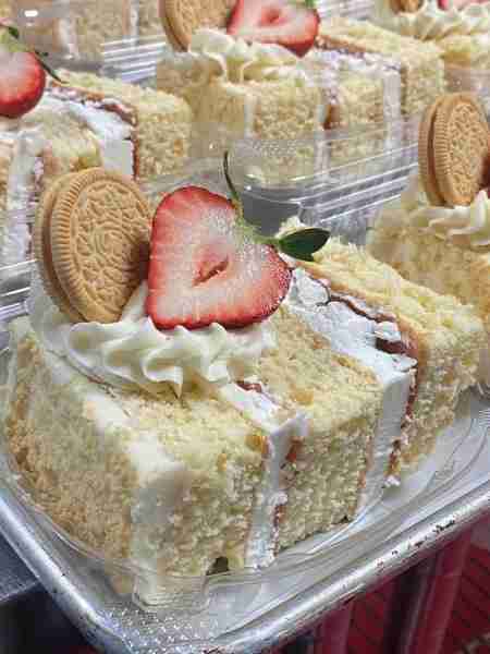 A delightful layered cake with a light and fluffy texture, whipped cream, and fresh fruit garnishes....