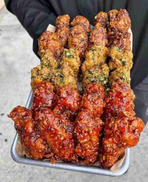 These crispy chicken wings appear to be coated in a delicious blend of sweet and spicy sauces, as we...