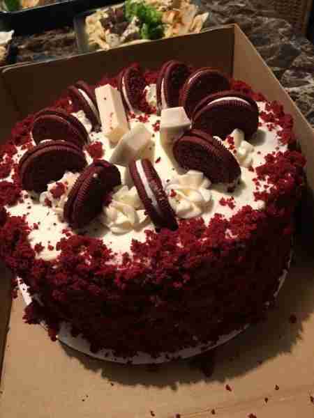 A delicious Red Velvet Cake topped with Oreo cookies, white chocolate pieces, and whipped cream. Ing...
