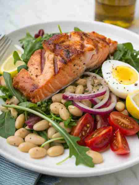 Arugula with grilled salmon, cannellini beans, cherry tomatoes, hard boiled egg, red onion, fresh le...