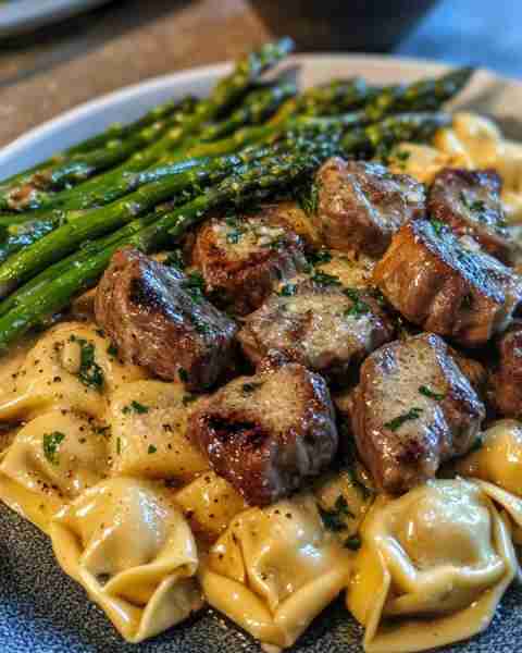 Garlic Steak Bites with Creamy Tortellini and Grilled Asparagus Ingredients: 1 lb sirloin steak, cut...