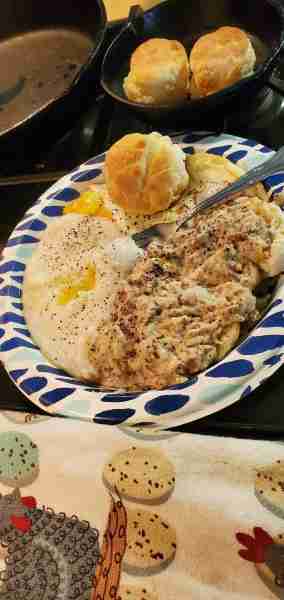 Breakfast, the way it ought to be. Buttermilk biscuits, sausage gravy, eggs over easy, grits with bu...
