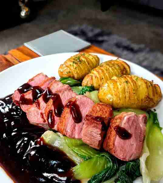 Duck breast with Pak Choi and hassle back potatoes and a thick plum sauce by Mark M