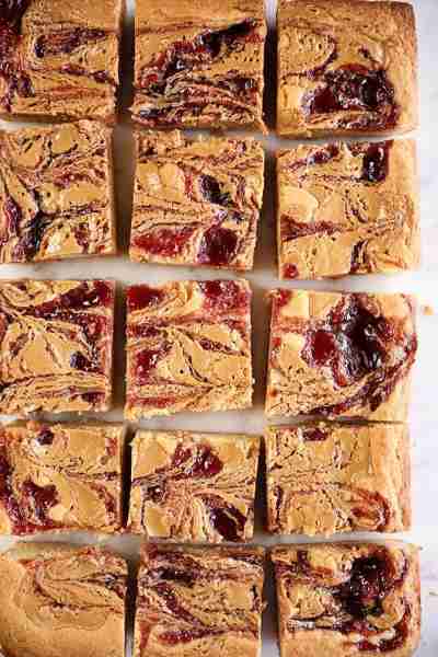 These Peanut Butter and Jelly Blondies remind me of one of my childhood favorites, a grilled PB&J! T...