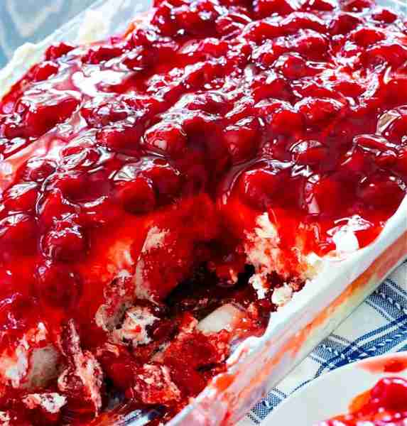 Cherry Poke Cake is an easy poke cake with a patriotic look. Made with a box of white cake mix, cher...