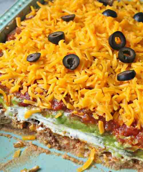 Ingredients 16 ounces refried beans 1 lb. ground beef milk cream cheese softened 1/2 cup sour cream...
