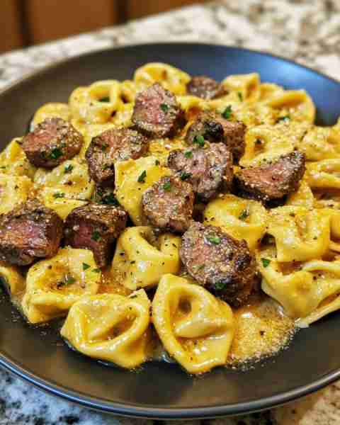 CHEESY GARLIC STEAK TORTELLINI Ingredients: 1 (20 oz) package refrigerated cheese tortellini 1½ lbs...
