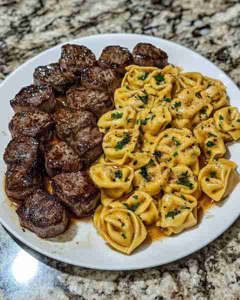 SMOTHERED STEAK BITES IN CREAMY VELVEETA TORTELLINI Ingredients: 1 lb steak (sirloin or ribeye), cut...