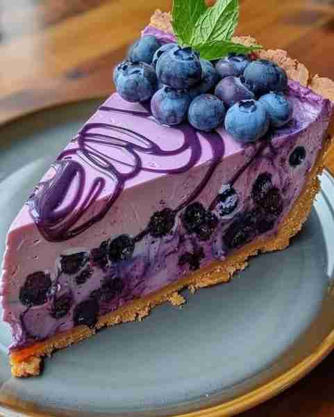 😋💜🍇 Irresistible Blueberry Dream Cheesecake Ingredients: 1 1/2 cups graham cracker crumbs 1/2 cup...