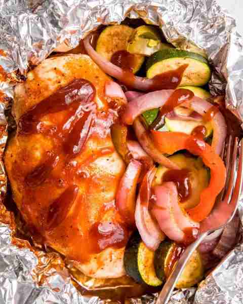 Smoky, saucy, and perfectly cooked in its own little pouch. This BBQ Chicken is perfect for camping!