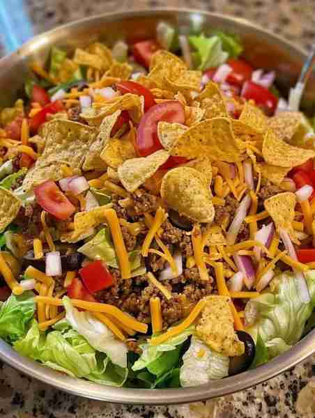 Dorito Taco Salad Ingredients 1 large bag Dorito Nacho Cheese Chips, broken into smaller pieces, but...