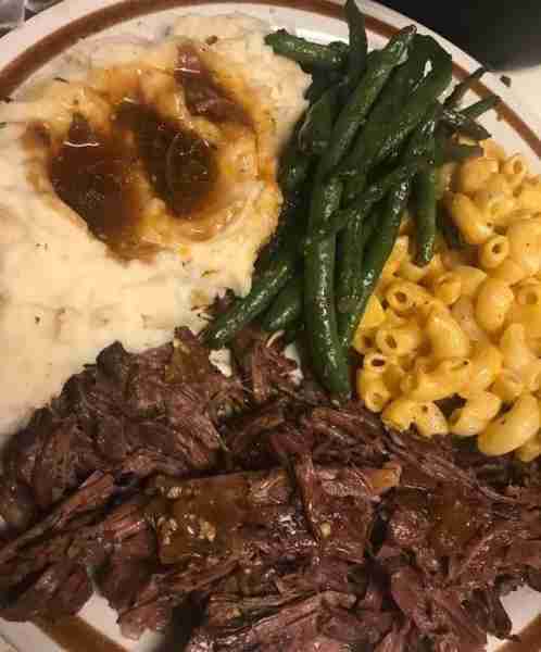 Roast, mashed potatoes and gravy, green beans and Mac and cheese.