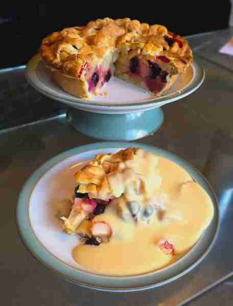 Homemade apple and blueberry pie with custard by Christopher