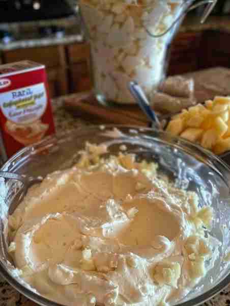A box of Angel Food Cake mix, and combine it with a 20 ounce can of crushed pineapple in its own jui...