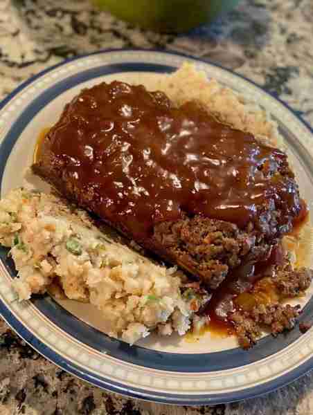 Mix ground beef, breadcrumbs, onion, garlic, eggs, milk, ketchup, Worcestershire sauce, salt, and pe...