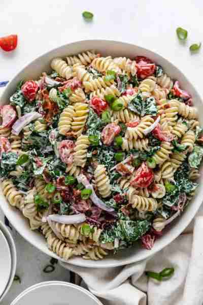 Our BLT Pasta Salad recipe combines rotini pasta with crispy bacon, romaine lettuce, red onion, and...