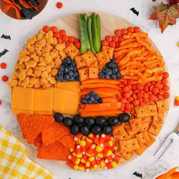 Pumpkin Charcuterie Board! 🎃 Loaded with dark berries, olives, peppers, crackers, chips, sliced che...