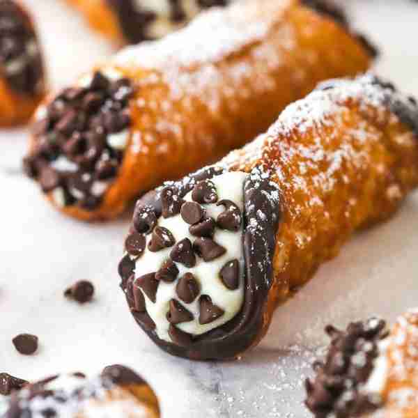 Thin, crispy shells are made and filled with a lightly sweet filling made with ricotta cheese, masca...