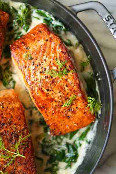 Salmon with Garlic Cream Sauce - Perfectly pan-seared salmon served with the most irresistible garli...